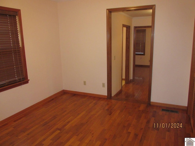 unfurnished room featuring dark hardwood / wood-style flooring