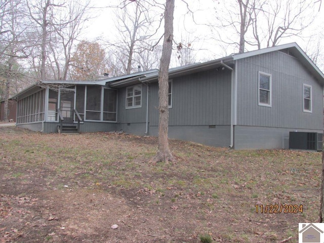 back of house featuring central air condition unit and a sunroom