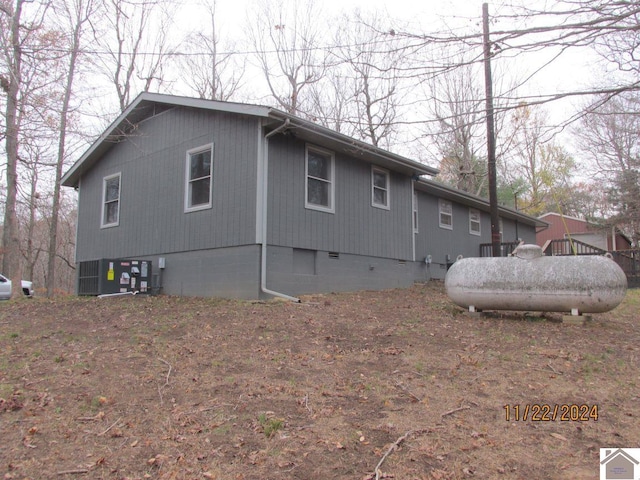 view of side of home with central AC unit