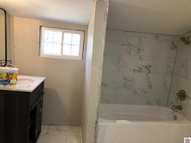 bathroom featuring vanity and tiled shower / bath combo