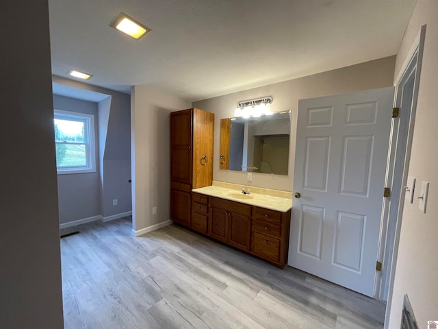 bathroom with vanity and hardwood / wood-style flooring