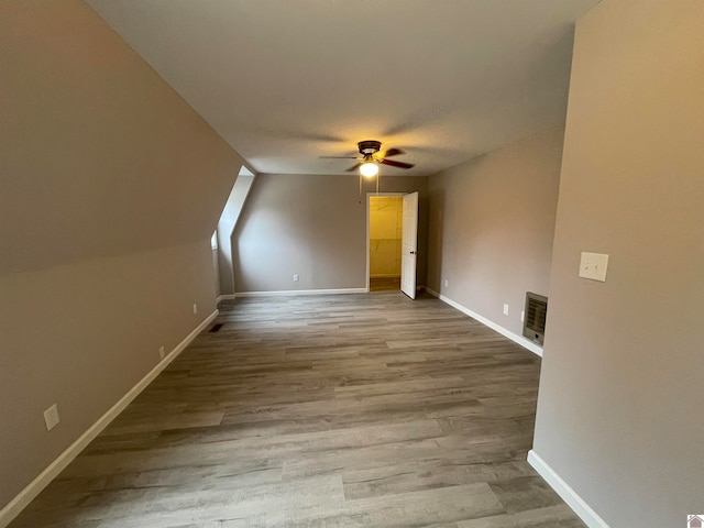 additional living space with ceiling fan, lofted ceiling, and light hardwood / wood-style flooring