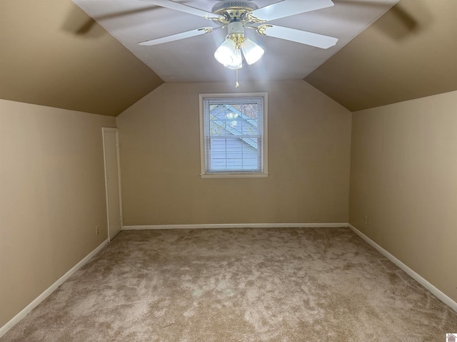 additional living space with ceiling fan, lofted ceiling, and light carpet