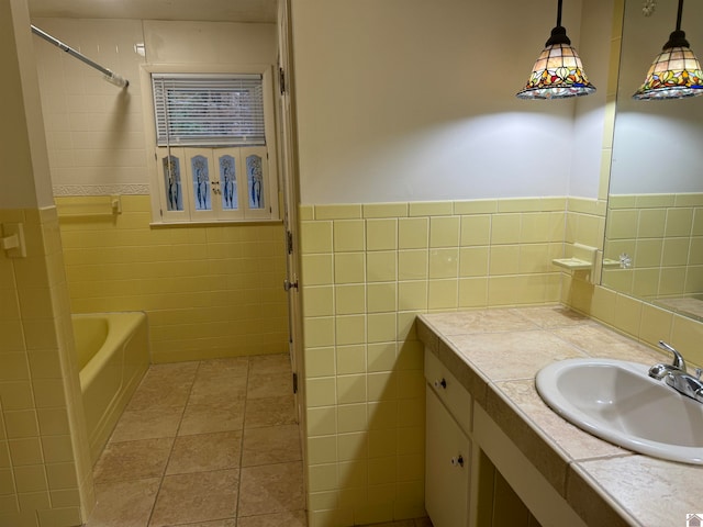 bathroom with tile patterned flooring, vanity, tile walls, and plus walk in shower