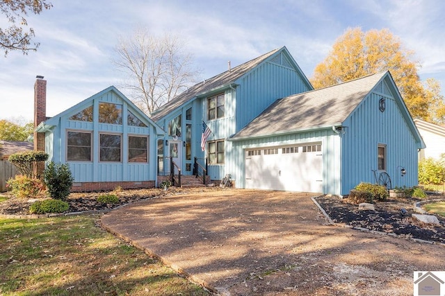 back of property featuring a garage