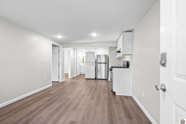 kitchen featuring white appliances, light hardwood / wood-style flooring, and white cabinetry