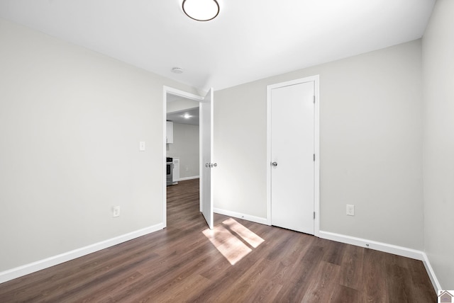 unfurnished bedroom featuring dark hardwood / wood-style floors