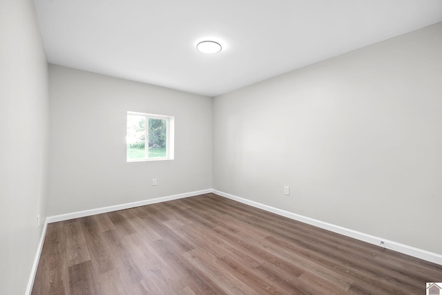 unfurnished room featuring hardwood / wood-style flooring