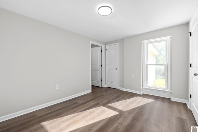 spare room with dark wood-type flooring