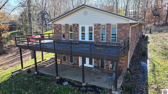 back of house featuring french doors, a deck, cooling unit, and a patio area