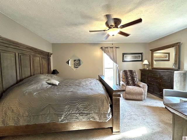 bedroom featuring a textured ceiling, ceiling fan, and light carpet