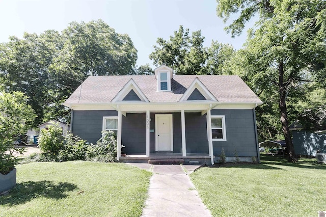 view of front of property with covered porch and a front lawn