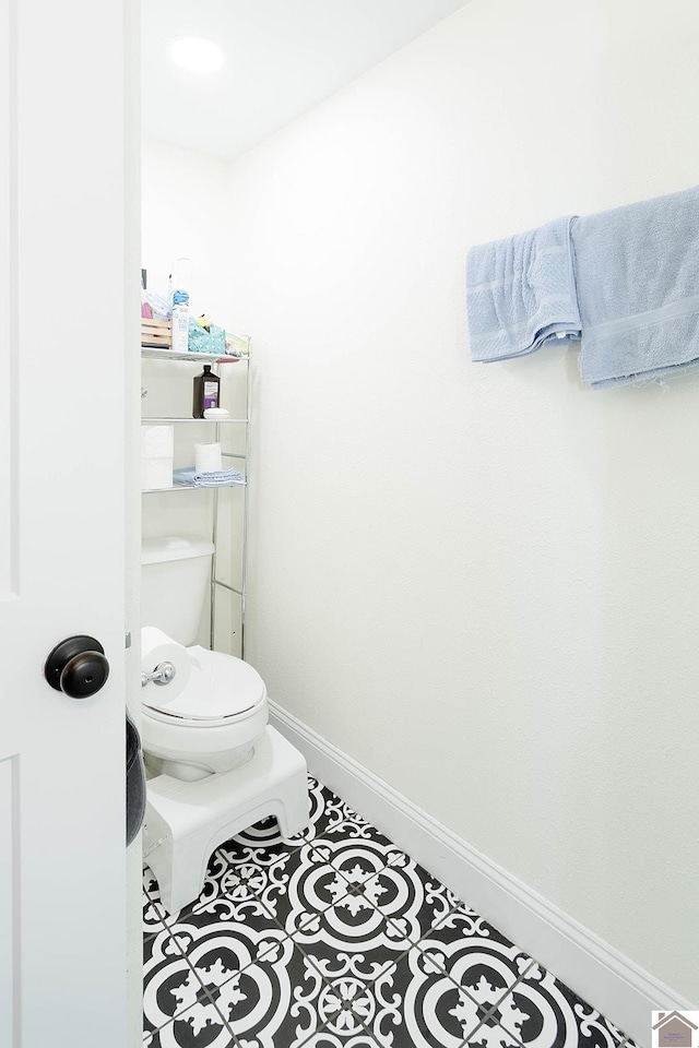 bathroom with tile patterned flooring and toilet