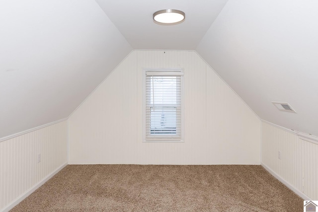 bonus room with carpet and vaulted ceiling