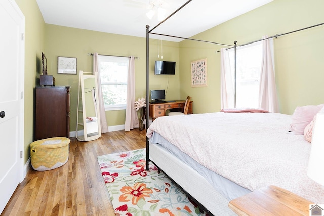 bedroom with light hardwood / wood-style floors and ceiling fan