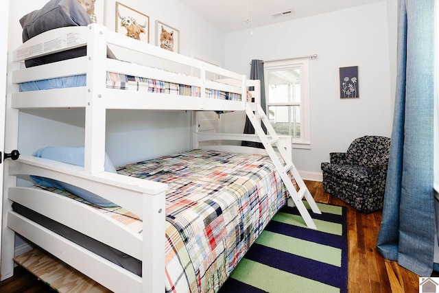 bedroom with dark hardwood / wood-style flooring