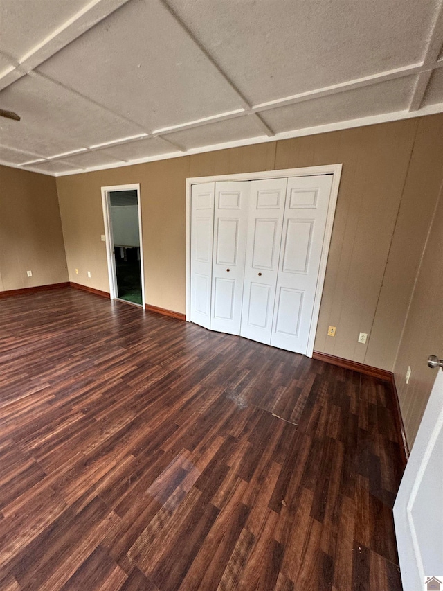 unfurnished bedroom featuring dark hardwood / wood-style flooring