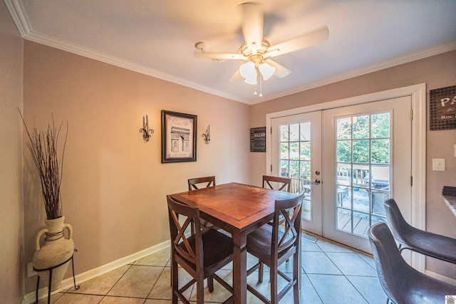 tiled dining space with ceiling fan, ornamental molding, and french doors