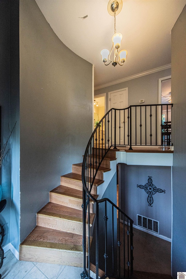 stairs featuring ornamental molding and an inviting chandelier