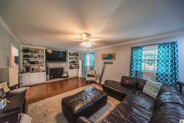 living room featuring plenty of natural light, dark hardwood / wood-style floors, and crown molding