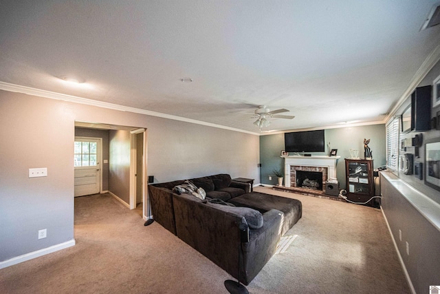 carpeted living room featuring a brick fireplace, ceiling fan, and crown molding