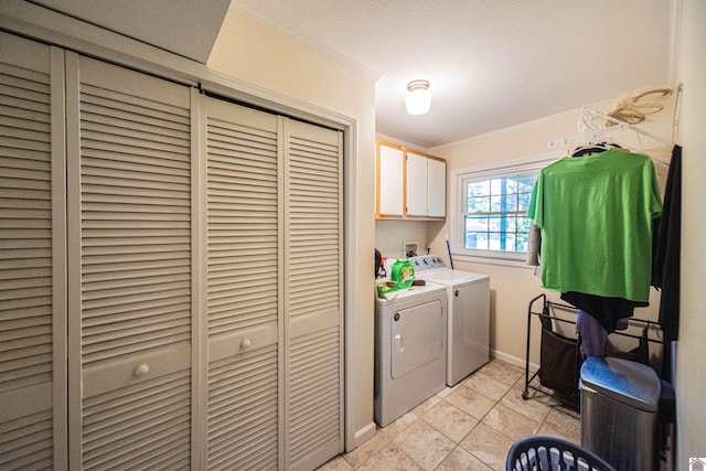 laundry area with cabinets, ornamental molding, a textured ceiling, light tile patterned floors, and separate washer and dryer