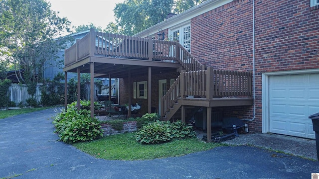 view of side of home with a garage and a wooden deck