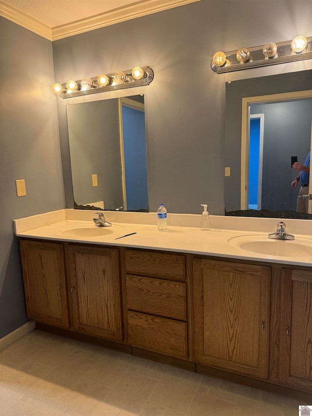 bathroom featuring crown molding and vanity