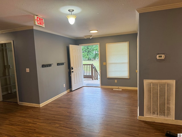 entryway with crown molding, dark wood-type flooring, and a textured ceiling