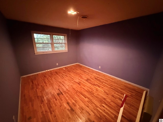 spare room with wood-type flooring