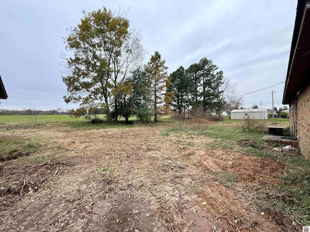 view of yard with a rural view