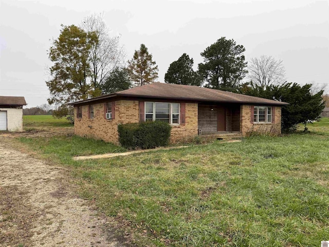 ranch-style house featuring cooling unit and a front yard