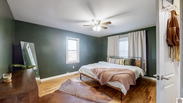 bedroom with ceiling fan and wood-type flooring