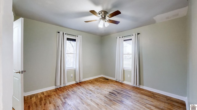 spare room featuring ceiling fan and light hardwood / wood-style flooring