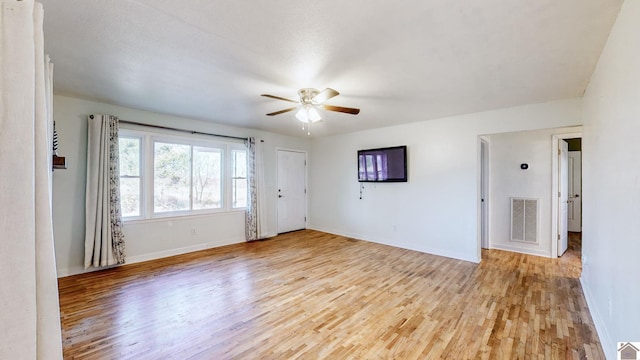 empty room with light hardwood / wood-style flooring and ceiling fan