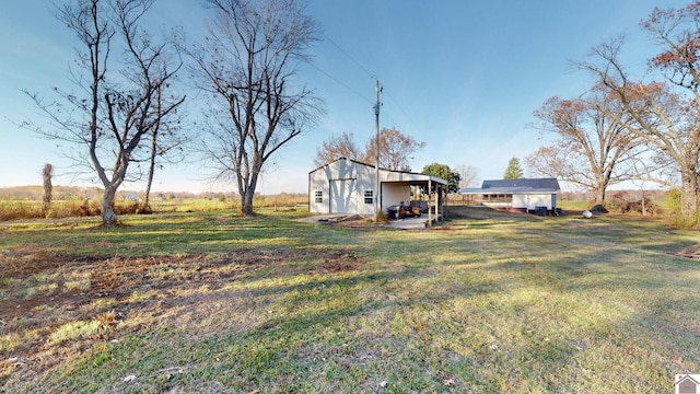 view of yard with an outbuilding and a rural view