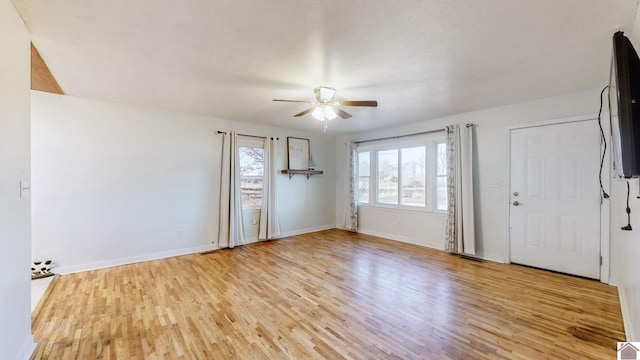 spare room featuring ceiling fan and light hardwood / wood-style flooring