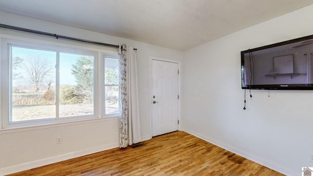 spare room with light hardwood / wood-style floors