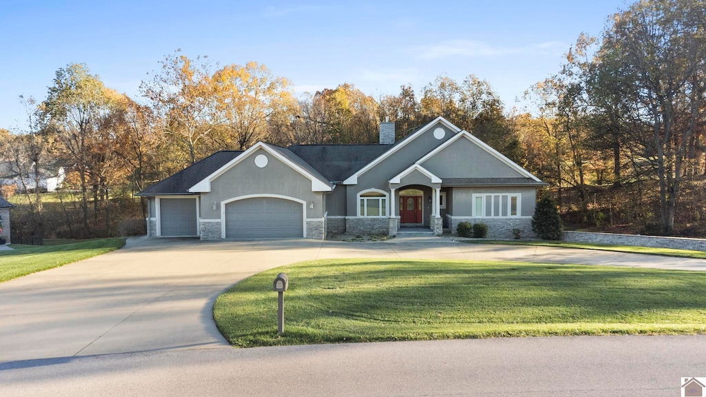 single story home featuring a garage and a front yard