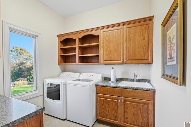 laundry area with light tile patterned flooring, cabinets, independent washer and dryer, and sink