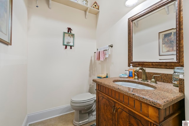 bathroom featuring tile patterned floors, vanity, and toilet