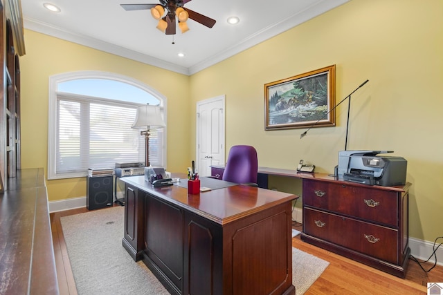 office space with crown molding, ceiling fan, and light hardwood / wood-style floors