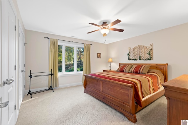 bedroom featuring ceiling fan and light colored carpet