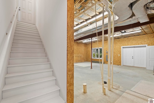 staircase featuring concrete flooring