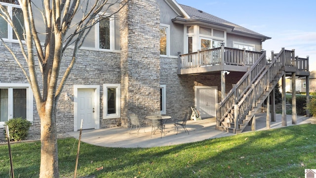 back of house with a yard, a patio area, and a wooden deck