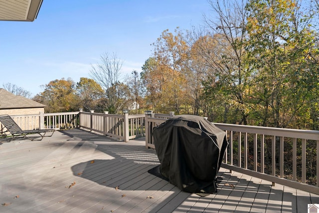 wooden terrace featuring a grill