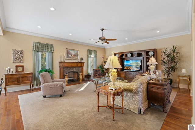 living room featuring light wood-type flooring, a fireplace, and ornamental molding