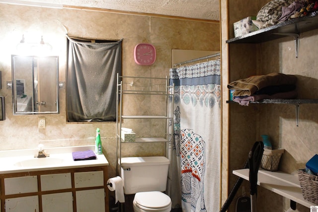 bathroom with toilet, vanity, and walk in shower