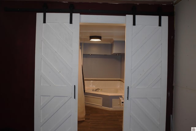 interior space with hardwood / wood-style floors and a bath