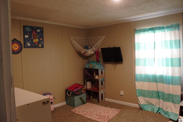 bedroom featuring a textured ceiling, carpet flooring, and ornamental molding